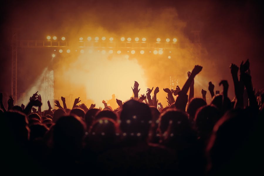 Singer performing on stage with colorful lights